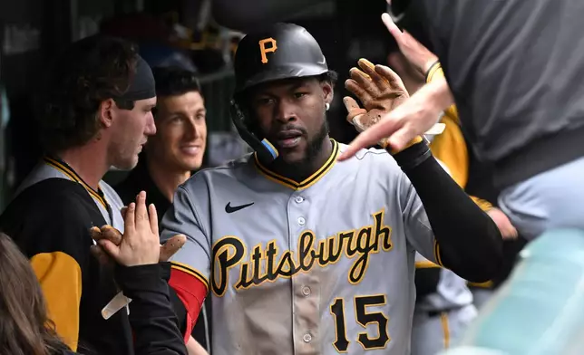 Pittsburgh Pirates' Oneil Cruz (15) celebrates in the dugout after scoring against the Chicago Cubs during the third inning of a baseball game, Saturday, April 11, 2026, in Chicago. (AP Photo/Matt Marton)