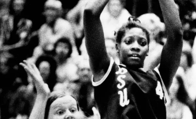 FILE - Delta State center Lusia Harris, right, towers over Penn State's Mag Strittmatter, left, as she pulls down a rebound at Penn State in University Park, Pa., March 24, 1976. (AP Photo, File)