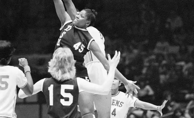 FILE - Delta State University's Lusia Harris (45) gets off a shot against Queens College during a women's college basketball game at Madison Square Garden in New York, Feb. 23, 1976. (AP Photo/Ron Frehm, File)