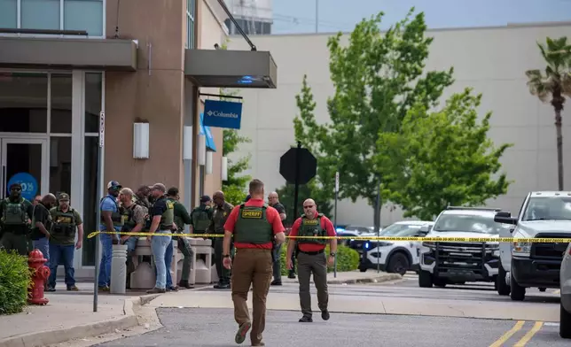 Law enforcement personnel respond to reports of a shooting at Mall of Louisiana in Baton Rouge, La., Thursday, April 23, 2026. (AP Photo/Matthew Hinton)