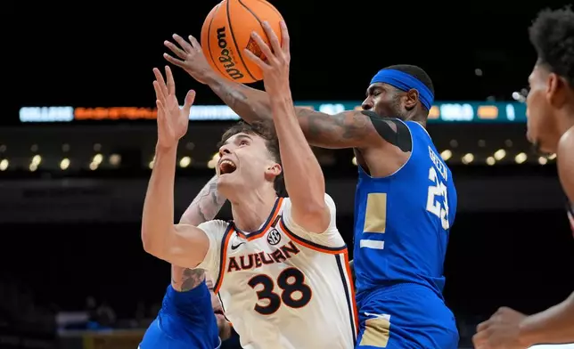 Auburn forward Filip Jovic (38) shoots past Tulsa forward David Green, right, during the first half of the NCAA college basketball NIT Championship game, Sunday, April 5, 2026, in Indianapolis. (AP Photo/Abbie Parr)