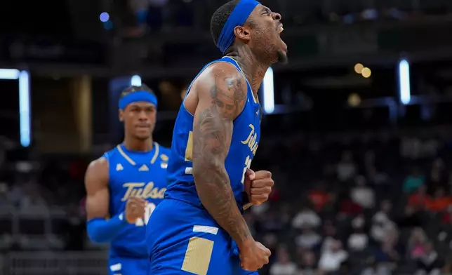 Tulsa forward David Green celebrates a basket against Auburn during the second half of the NCAA college basketball NIT Championship game, Sunday, April 5, 2026, in Indianapolis. (AP Photo/Abbie Parr)