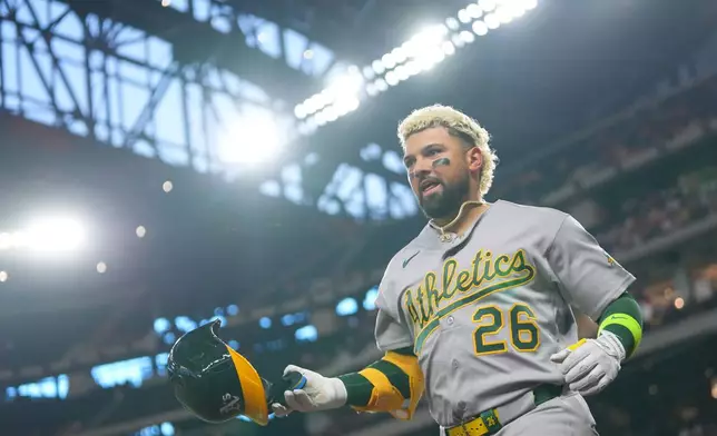 Athletics' Carlos Cortes reacts while running the bases after hitting a solo home run off Texas Rangers starting pitcher Nathan Eovaldi during the first inning of a baseball game Friday, April 24, 2026, in Arlington, Texas. (AP Photo/Julio Cortez)