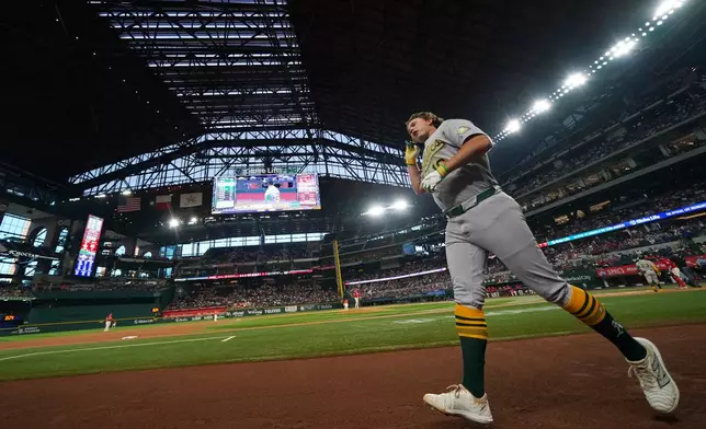 Athletics' Nick Kurtz runs to the dugout after hitting a leadoff home run on the first pitch from Texas Rangers starting pitcher Nathan Eovaldi during the first inning of a baseball game Friday, April 24, 2026, in Arlington, Texas. (AP Photo/Julio Cortez)