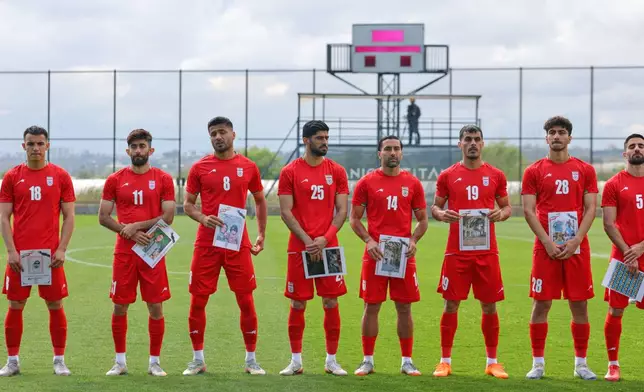 Iran's player pose for photographers holding pictures of children allegedly killed in a U.S. strikes in Iran, before a friendly soccer match between Iran and Costa Rica, in Antalya, southern Turkey, Tuesday, March 31, 2026. (AP Photo/Riza Ozel)