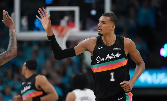 San Antonio Spurs forward Victor Wembanyama (1) celebrates a play against the Portland Trail Blazers during the first half in Game 1 of a first-round NBA playoffs basketball series in San Antonio, Sunday, April 19, 2026. (AP Photo/Eric Gay)