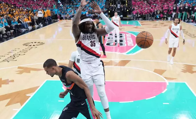 Portland Trail Blazers center Robert Williams III (35) scores over San Antonio Spurs forward Victor Wembanyama (1) during the first half in Game 1 of a first-round NBA playoffs basketball series in San Antonio, Sunday, April 19, 2026. (AP Photo/Eric Gay)