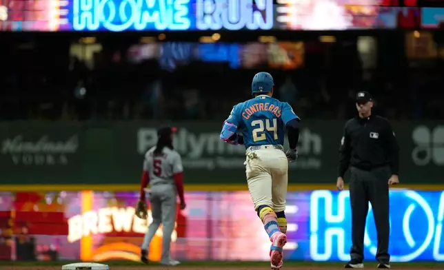 Milwaukee Brewers' William Contreras rounds the bases after hitting a solo home run during the ninth inning of a baseball game against the Washington Nationals, Saturday, April 11, 2026, in Milwaukee. (AP Photo/Aaron Gash)