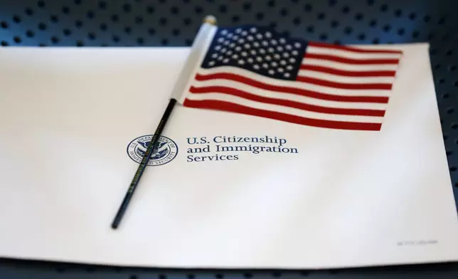 FILE - An information packet and an American flag are placed on a chair at the U.S. Citizenship and Immigration Services Miami Field Office on Aug. 17, 2018, in Miami. (AP Photo/Wilfredo Lee, File)