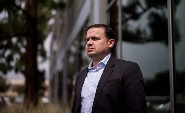 Milenko Faria, whose wife, Dr. Rubeliz Bolivar, is in immigration custody, stands for a portrait after his asylum interview at the U.S. Citizenship and Immigration Services facility in Tustin, Calif., Thursday, April 16, 2026. (AP Photo/Jae C. Hong)