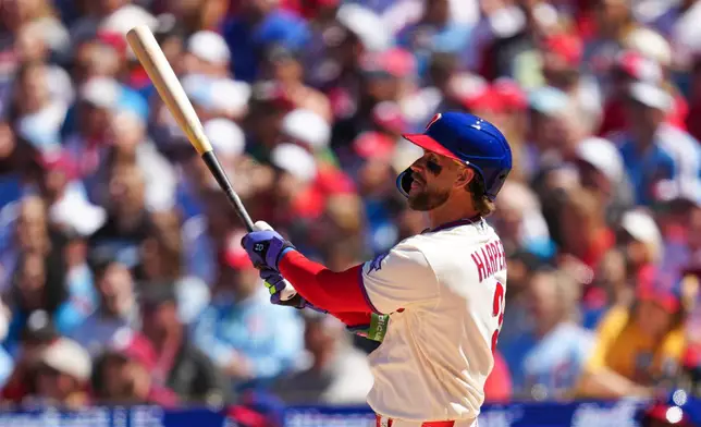 Philadelphia Phillies' Bryce Harper watches his solo home run off Arizona Diamondbacks pitcher Brandon Pfaadt during the third inning of a baseball game, Saturday, April 11, 2026, in Philadelphia. (AP Photo/Derik Hamilton)
