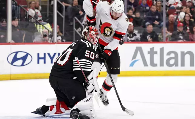 New Jersey Devils goaltender Nico Daws defends against Ottawa Senators left wing Warren Foegele (37) during the first period of an NHL hockey game Sunday, April 12, 2026, in Newark, N.J. (AP Photo/Adam Hunger)
