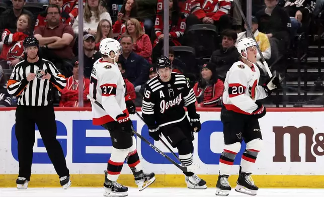 Ottawa Senators left wing Fabian Zetterlund (20) reacts after scoring in front of New Jersey Devils center Jack Hughes (86) during the second period of an NHL hockey game Sunday, April 12, 2026, in Newark, N.J. (AP Photo/Adam Hunger)