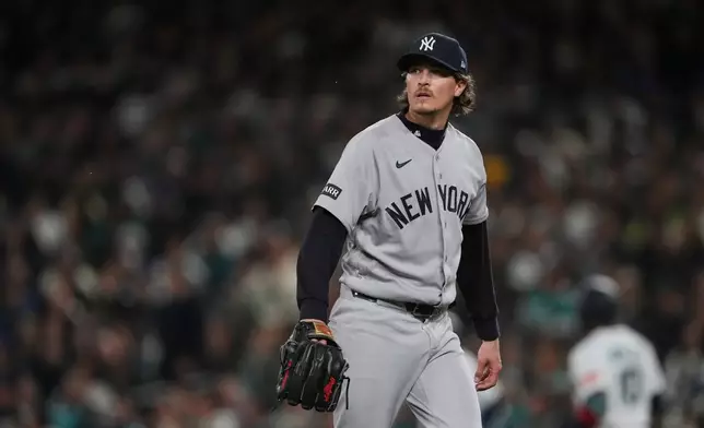 New York Yankees starting pitcher Max Fried walks to the dugout after retiring the side against the Seattle Mariners during the seventh inning of a baseball game, Tuesday, March 31, 2026, in Seattle. (AP Photo/Lindsey Wasson)