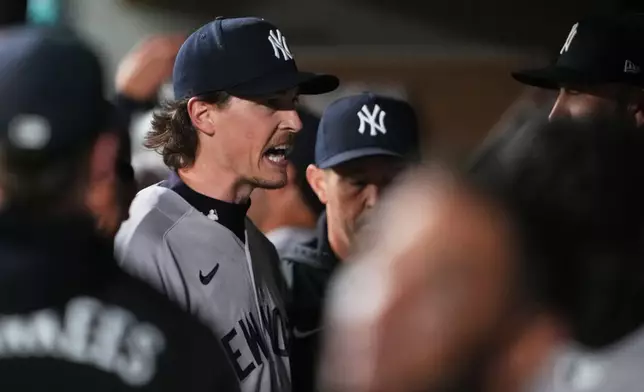 New York Yankees starting pitcher Max Fried greets teammates in the dugout after the seventh inning of a baseball game against the Seattle Mariners, Tuesday, March 31, 2026, in Seattle. (AP Photo/Lindsey Wasson)