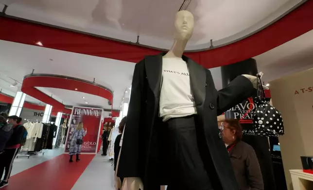 Visitors enjoy an installation of the new movie 'The Devil Wears Prada 2' at La Rinascente shopping center, in Milan, Italy, Monday, April 20, 2026. (AP Photo/Luca Bruno)