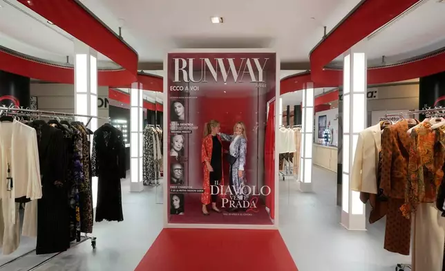 Visitors enjoy an installation of the new movie 'The Devil Wears Prada 2' at La Rinascente shopping center, in Milan, Italy, Monday, April 20, 2026. (AP Photo/Luca Bruno)