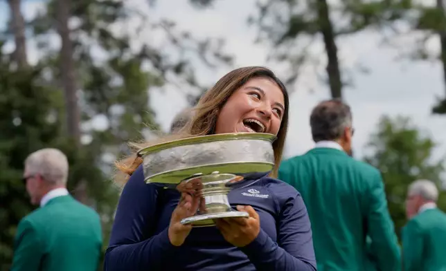 Maria José Marin, of Colombia, holds the trophy after winning the Augusta National Women's Amateur golf tournament, Saturday, April 4, 2026, in Augusta, Ga. (AP Photo/David J. Phillip)