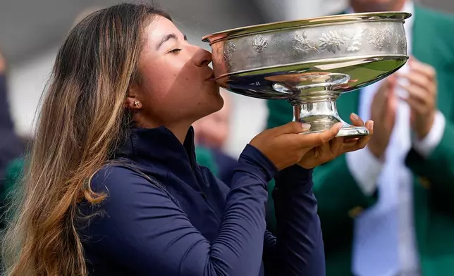 Maria José Marin, of Colombia, kisses the trophy after winning the Augusta National Women's Amateur golf tournament, Saturday, April 4, 2026, in Augusta, Ga. (AP Photo/David J. Phillip)