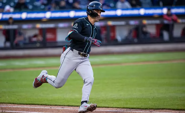 Arizona Diamondbacks' Corbin Carroll (7) triples during the seventh inning of a baseball game against the New York Mets, Wednesday, April 8, 2026, in New York. (AP Photo/Angelina Katsanis)