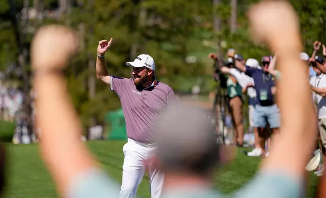 Shane Lowry, of Ireland, waves after a hole-in-one on the sixth hole during the third round of the Masters golf tournament at the Augusta National Golf Club, Saturday, April 11, 2026, in Augusta, Ga. (AP Photo/Ashley Landis)