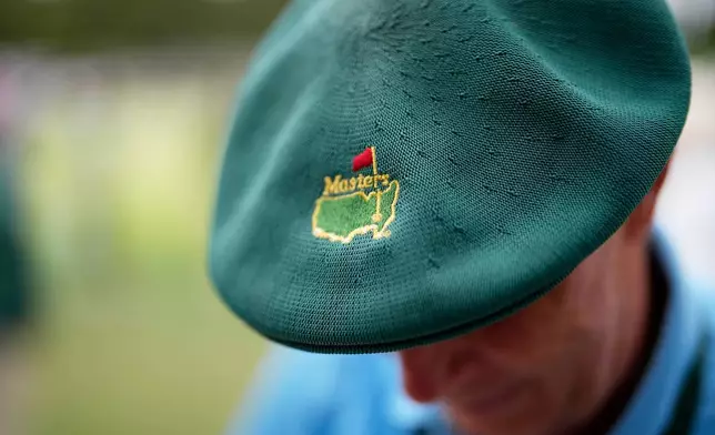 A patron sports a green Masters beret while attending a practice round ahead at the Augusta National Golf Club, in Augusta, Ga. , Monday, April 6, 2026. (AP Photo/David J. Phillip)