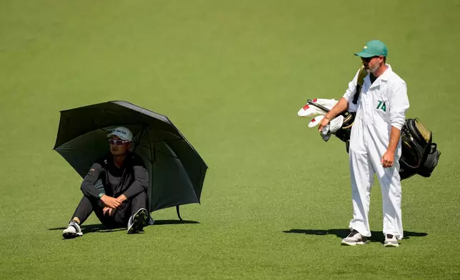 Haotong Li, of China, waits to play on the second hole during the second round of the Masters golf tournament at the Augusta National Golf Club, Friday, April 10, 2026, in Augusta, Ga. (AP Photo/Gerald Herbert)