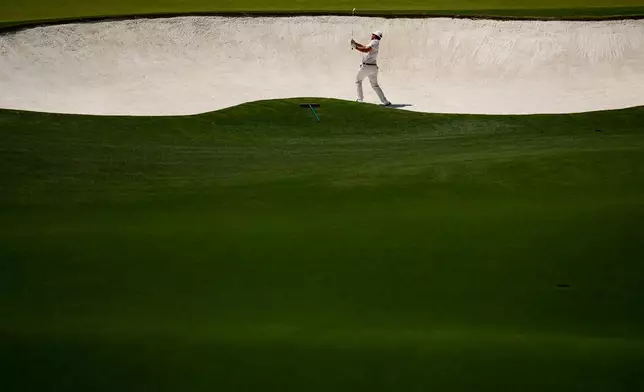 Xander Schauffele hits from the bunker on the fourth hole during the third round of the Masters golf tournament at the Augusta National Golf Club, Saturday, April 11, 2026, in Augusta, Ga. (AP Photo/Gerald Herbert)