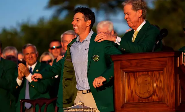 Augusta National Golf Club chairman Fred Ridley puts the green Jacket on Rory McIlroy, of Northern Ireland, after the Masters golf tournament at the Augusta National Golf Club, Sunday, April 12, 2026, in Augusta, Ga.(AP Photo/Ashley Landis)