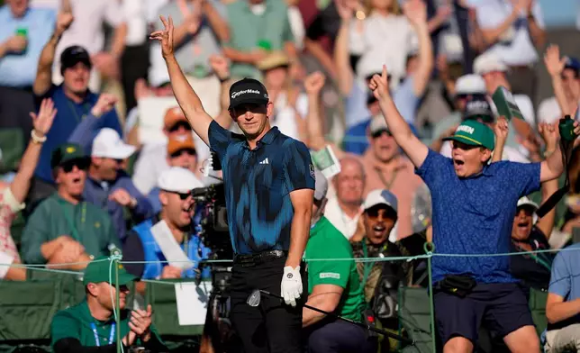 Jacob Bridgeman celebrate after chipping in on the 18th hole during the first round of the Masters golf tournament at the Augusta National Golf Club, Thursday, April 9, 2026, in Augusta, Ga. (AP Photo/David J. Phillip)