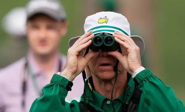 A course worker watches during a practice round ahead of the Masters golf tournament at the Augusta National Golf Club, Tuesday, April 7, 2026, in Augusta, Ga. (AP Photo/Eric Gay)