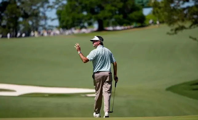 Bubba Watson waves after his putt on the 10th hole during the second round of the Masters golf tournament at the Augusta National Golf Club, Friday, April 10, 2026, in Augusta, Ga. (AP Photo/Gerald Herbert)