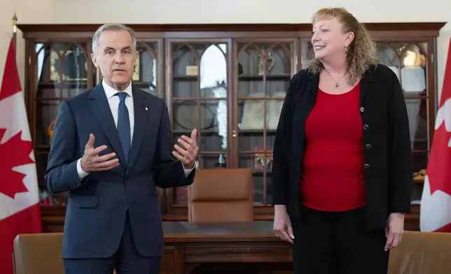 Prime Minister Mark Carney delivers some remarks as MP for Sarnia-Lambton-Bkejwanong Marilyn Gladu looks on during an event in his office in Ottawa, Wednesday, April 8, 2026. (Adrian Wyld /The Canadian Press via AP)