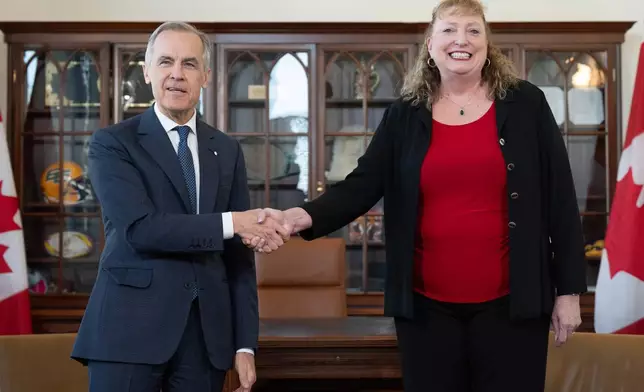 Prime Minister Mark Carney shakes hands with MP for Sarnia-Lambton-Bkejwanong Marilyn Gladu in Ottawa, Wednesday, April 8, 2026. (Adrian Wyld /The Canadian Press via AP)