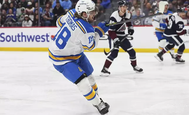 St. Louis Blues center Robert Thomas scores a goal against the Colorado Avalanche in the second period of an NHL hockey game Sunday, April 5, 2026, in Denver. (AP Photo/David Zalubowski)