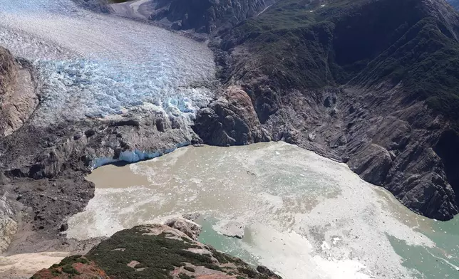 This photo provided by the U.S. Geological Survey shows the terminus of the South Sawyer Glacier in Tracy Arm fjord, alongside the remains of a landslide, left, that occurred days earlier, Aug. 13, 2025, about 80 miles southeast of Juneau, Alaska. (John Lyons/U.S. Geological Survey via AP)