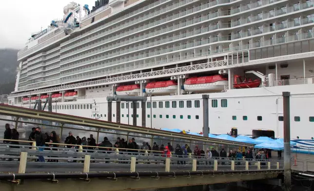 FILE - Passengers stream off the Norwegian Bliss after the vessel arrived, in Juneau, Alaska, April 25, 2022. (AP Photo/Becky Bohrer, File)