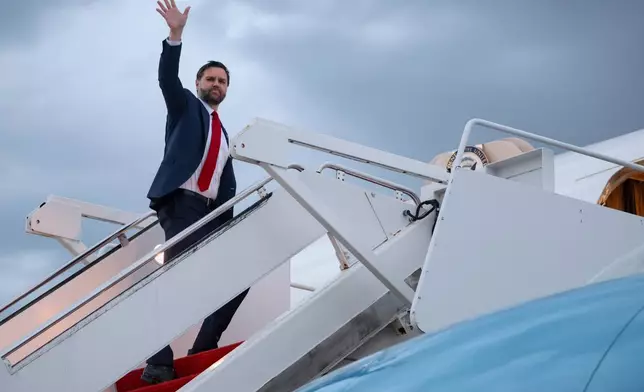Vice President JD Vance waves as he boards Air Force Two to depart for Budapest, at Joint Base Andrews, Md., Monday, April 6, 2026. (Jonathan Ernst/Pool via AP)