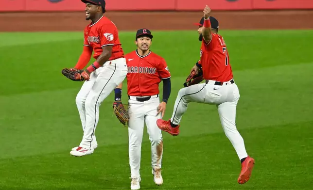 From left, Cleveland Guardians left fielder Angel Martinez, center fielder Steven Kwan, center, and right fielder George Valera celebrate a win over the Houston Astros in Cleveland, Tuesday, April 21, 2026. (AP Photo/David Richard)