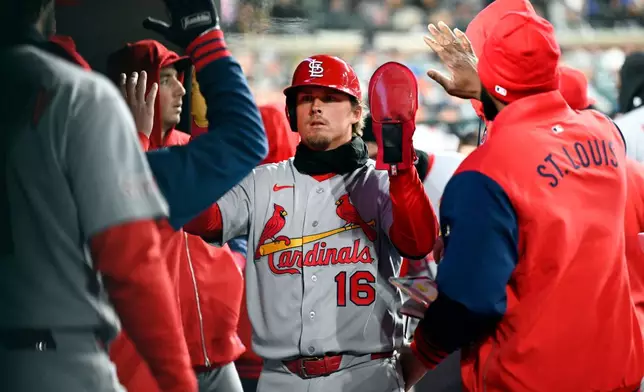 St. Louis Cardinals' Nolan Gorman (16) is congratulated in the dugout after scoring on an RBI single by Pedro Pagés in the fifth inning of a baseball game, Sunday, April 5, 2026, in Detroit. (AP Photo/Jose Juarez)
