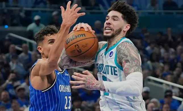 Charlotte Hornets guard LaMelo Ball, right, goes to the basket against Orlando Magic forward Tristan da Silva (23) during the second half of an NBA play-in tournament basketball game, Friday, April 17, 2026, in Orlando, Fla. (AP Photo/John Raoux)