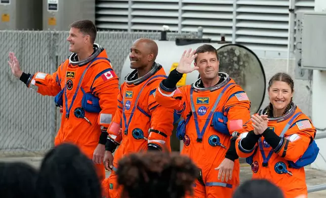 Astronauts , from left, Mission Specialist Jeremy Hansen, of Canada, Pilot Victor Glover, Commander Reid Wiseman and Mission Specialist Christina Koch leave the Operations and Checkout Building for a trip to Launch Pad 39-B and a planned liftoff on NASA's Artemis II moon rocket at the Kennedy Space Center Wednesday, April 1, 2026, in Cape Canaveral, Fla. (AP Photo/Chris O'Meara)