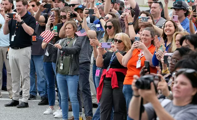 NASA emplyees react as astronauts leave the Operations and Checkout Building for a trip to Launch Pad 39-B and a planned liftoff on NASA's Artemis II moon rocket at the Kennedy Space Center Wednesday, April 1, 2026, in Cape Canaveral, Fla. (AP Photo/Chris O'Meara)