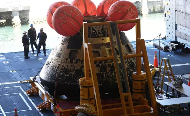 NASA's Artemis II capsule is seen aboard the USS John P. Murtha at Naval Base San Diego Saturday, April 11, 2026, in San Diego. (AP Photo/Gregory Bull)
