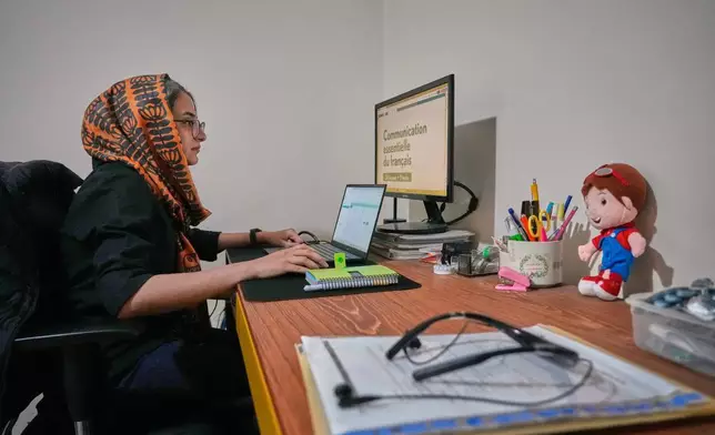 Zahra Arghavan works on her computer at home in Tehran, Iran, Sunday, April 5, 2026. (AP Photo/Vahid Salemi)