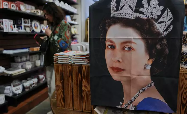 Tea towel with photo of late Queen Elizabeth II is on display for sale at a souvenirs shop in London, on April 17, 2026. (AP Photo/Kin Cheung)