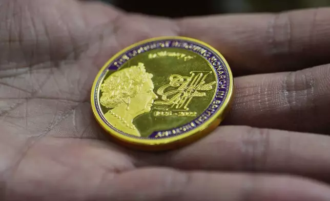 A coin featuring the late Queen Elizabeth II is on display for sale at a souvenirs shop in London, on April 17, 2026. (AP Photo/Kin Cheung)