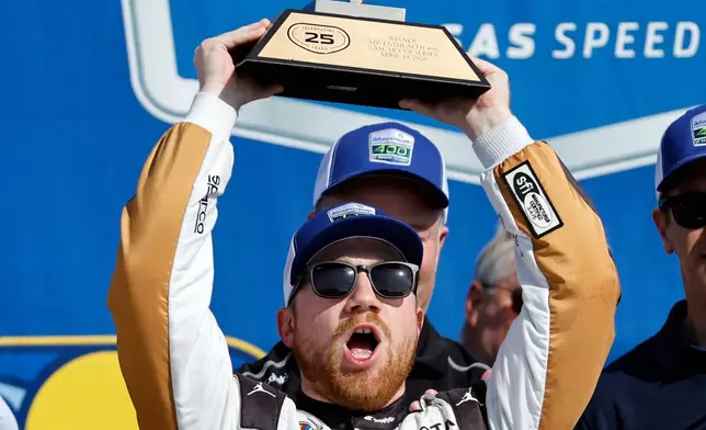 Tyler Reddick celebrates in Victory Lane after winning a NASCAR Cup Series auto race at Kansas Speedway in Kansas City, Kan., Sunday, April 19, 2026. (AP Photo/Colin E. Braley)