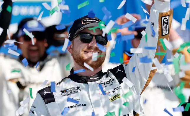 Tyler Reddick celebrates in Victory Lane after winning a NASCAR Cup Series auto race at Kansas Speedway in Kansas City, Kan., Sunday, April 19, 2026. (AP Photo/Colin E. Braley)