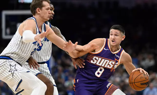 Phoenix Suns guard Grayson Allen (8) is defended by Orlando Magic forward Moritz Wagner, left, and forward Jamal Cain (8) during the first half of an NBA basketball game, Tuesday, March 31, 2026, in Orlando, Fla. (AP Photo/Phelan M. Ebenhack)